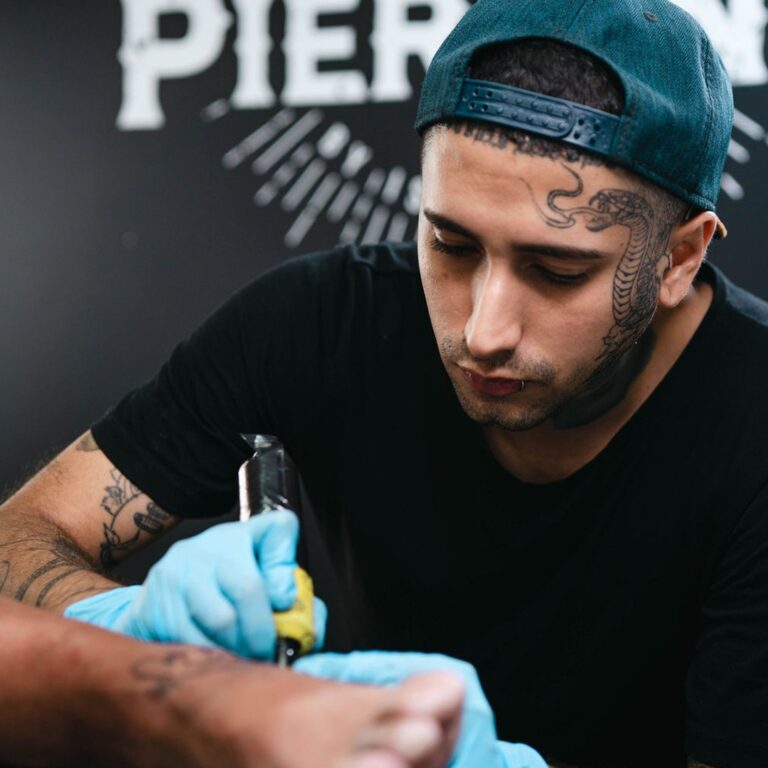 tattoo shop artists tattooing a customer