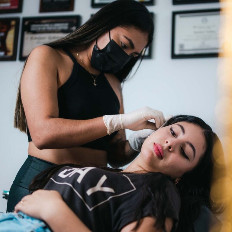 tattoo shop girl piercing a customer